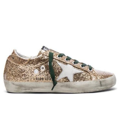 Golden Goose Superstar metallic gold glitter with a white leather star patch and dark green laces