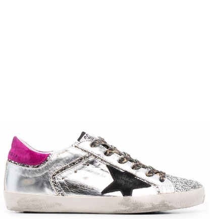 Golden Goose Superstar sneakers featuring a silver leather upper a black suede star and a magenta suede heel tab